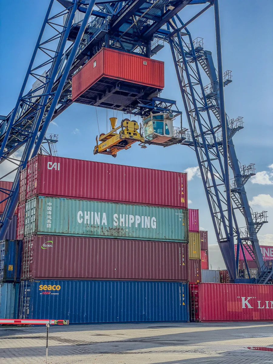 A gantry crane lifting a shipping container at a port